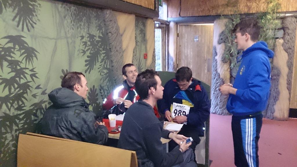After running Rob gives details of conditions out on the course to the Senior Men, who are  wisely sheltering from the downpour in the cafe.
