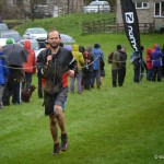 A muddy Tom crosses the line